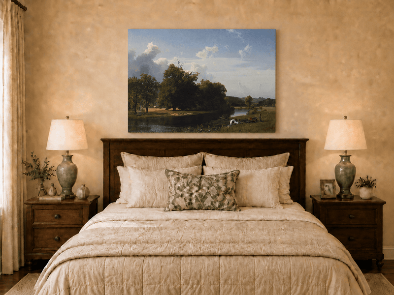 Unframed hand-painted riverside oil painting with a large oak tree, boat and distant cottage displayed above a wooden bed in a neutral bedroom.