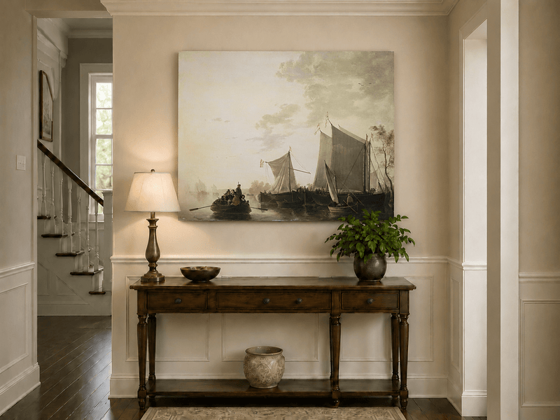 Unframed hand-painted riverside oil painting with sailing ships and figures displayed above an entryway console table.