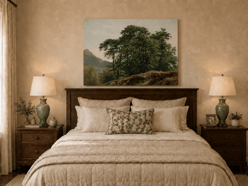 Unframed hand-painted landscape oil painting with a rocky hillside, oak tree and distant mountains displayed above a wooden bed in a neutral bedroom.