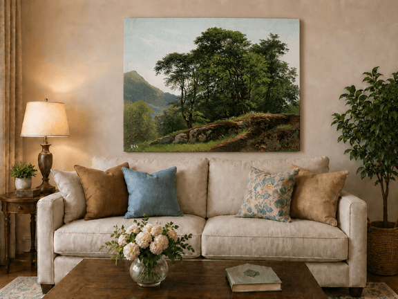 Unframed hand-painted landscape oil painting with a rocky hillside, oak tree and distant mountains displayed above a neutral living room sofa.