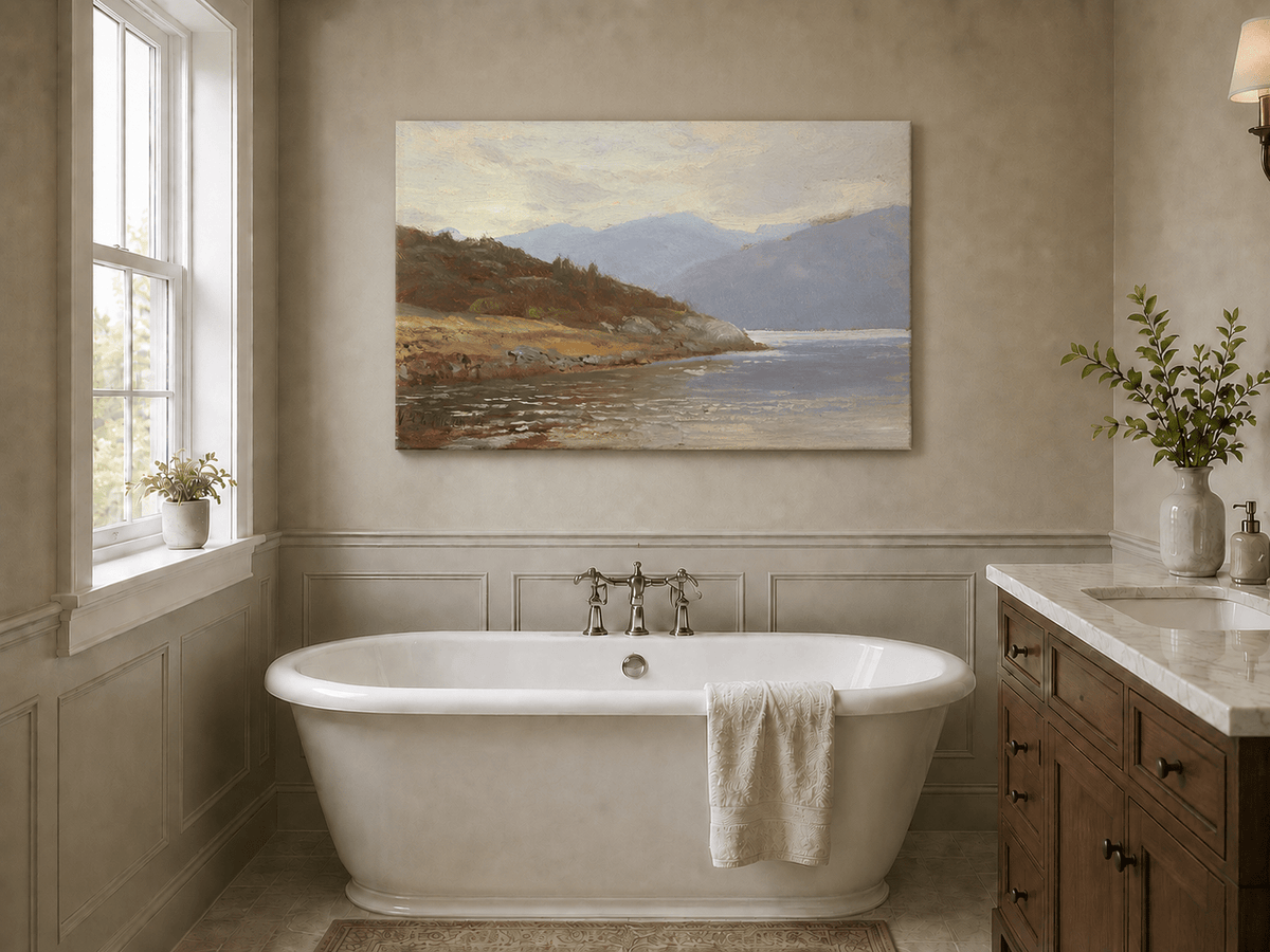 Unframed hand-painted lake shore oil painting with rocky banks, vegetation and mountain ranges displayed above a freestanding bathtub.