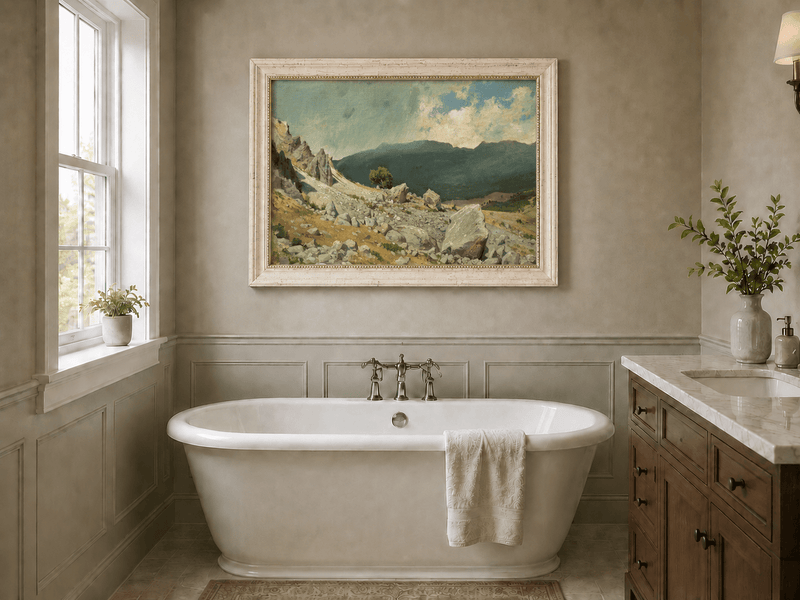 Framed hand-painted alpine oil painting with a rocky slope and distant mountain peaks displayed above a freestanding bathtub.