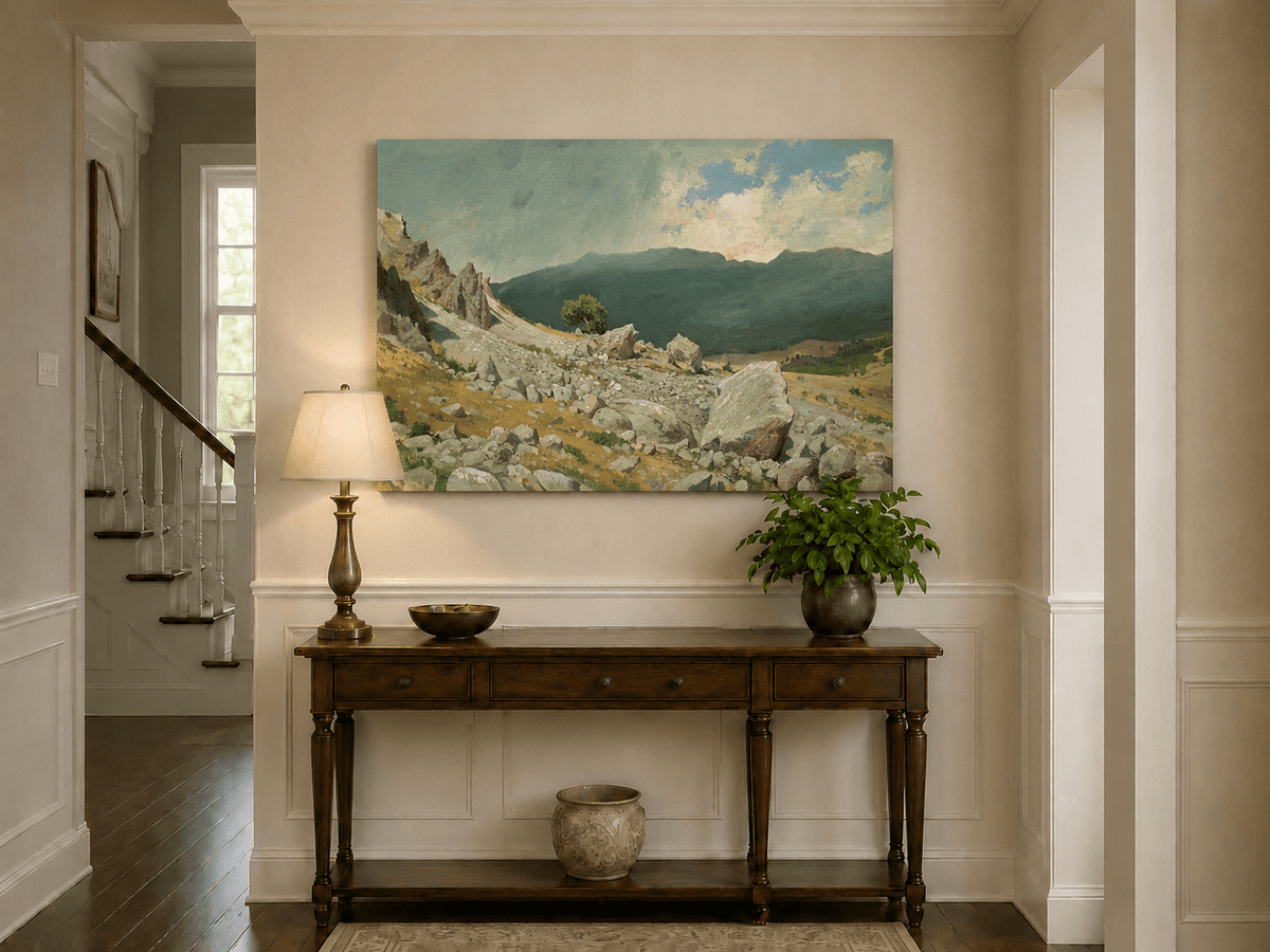 Unframed hand-painted alpine oil painting with a rocky slope and distant mountain peaks displayed above an entryway console table.