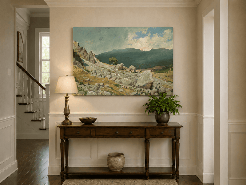 Unframed hand-painted alpine oil painting with a rocky slope and distant mountain peaks displayed above an entryway console table.