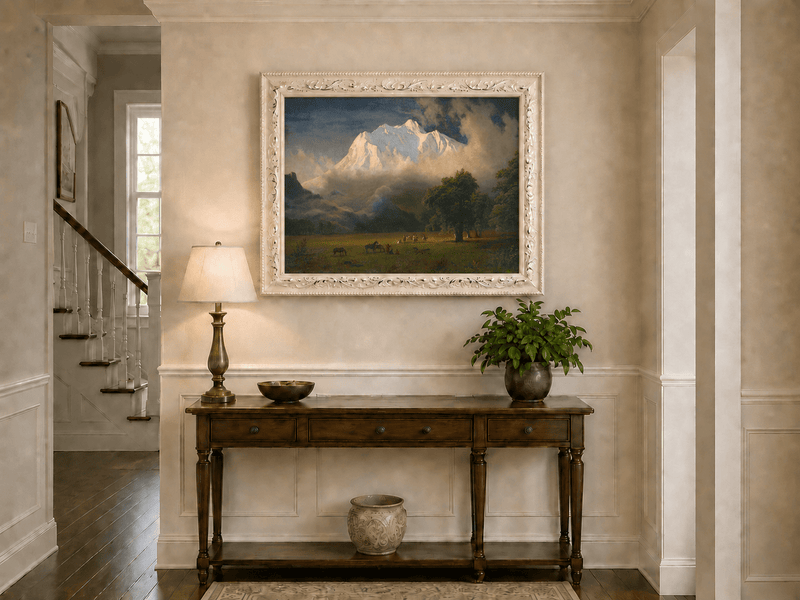 Framed hand-painted Rocky Mountains oil painting of Lander's Peak above a dramatic valley displayed above an entryway console table.