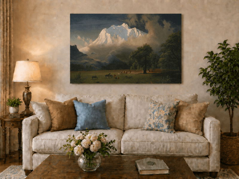 Unframed hand-painted Rocky Mountains oil painting of Lander's Peak above a dramatic valley displayed above a neutral living room sofa.