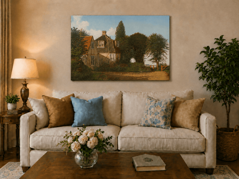 Unframed hand-painted rural cottage oil painting with half-timbered walls, tiled roofs and trees displayed above a neutral living room sofa.