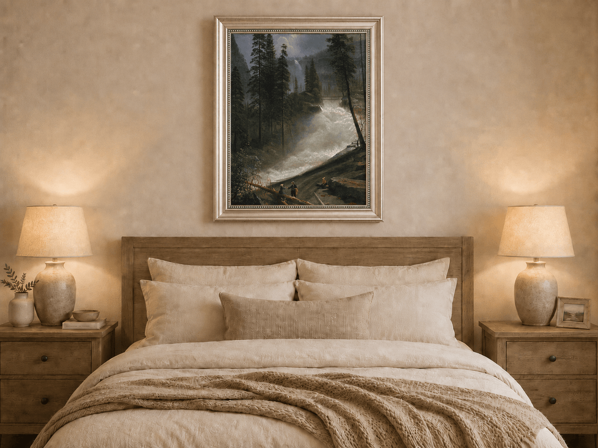 Framed hand-painted forest oil painting with figures beside a rushing river and waterfall displayed above a wooden bed in a neutral bedroom.