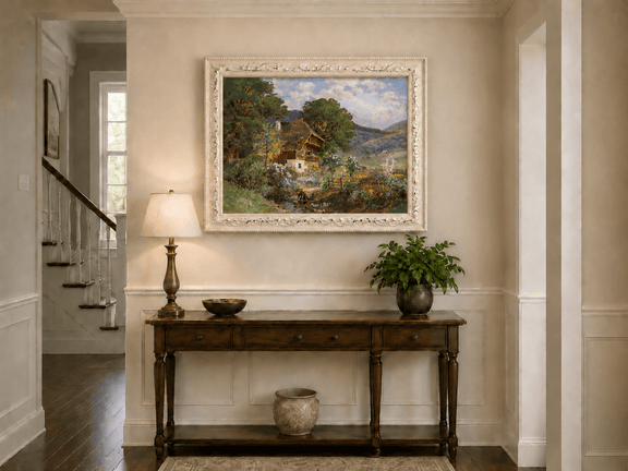 Framed hand-painted rustic cottage oil painting in a colorful mountain valley displayed above an entryway console table.