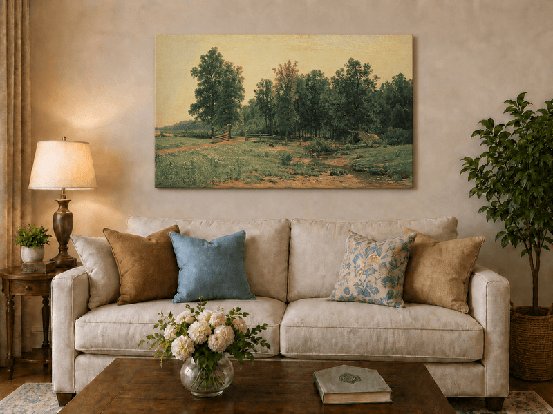 Unframed hand-painted rustic meadow oil painting with a stream and distant forest edge displayed above a neutral living room sofa.