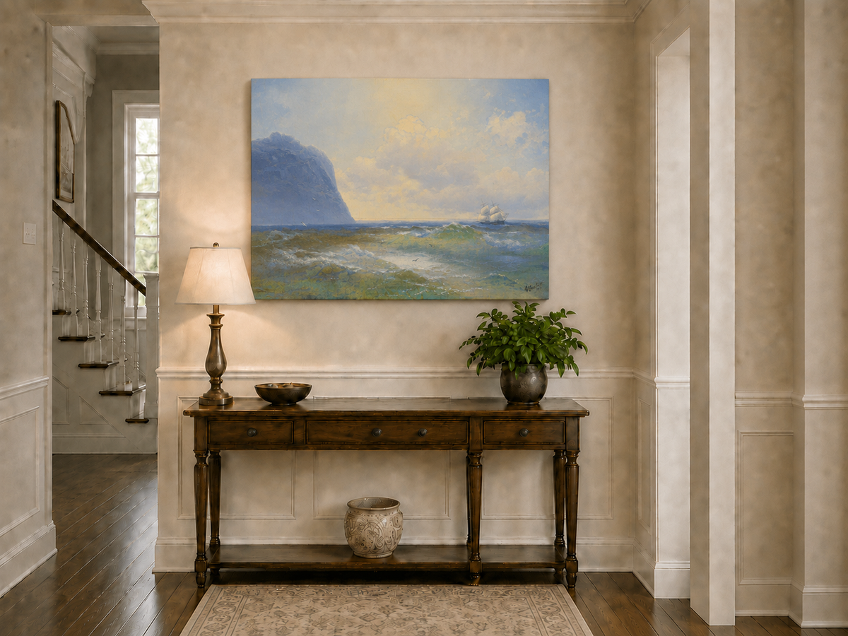 Hand-painted sailing beyond the blue cliff seascape oil painting displayed above a console table in a hallway interior.