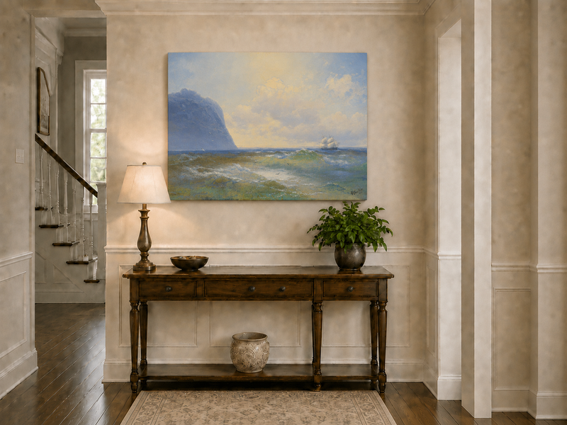Hand-painted sailing beyond the blue cliff seascape oil painting displayed above a console table in a hallway interior.
