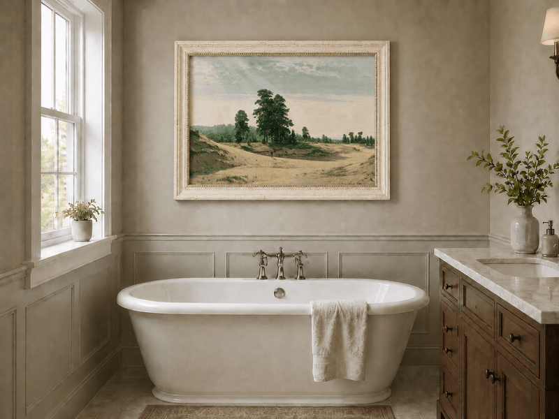 Framed hand-painted sandy forest clearing oil painting with a distant figure displayed above a freestanding bathtub.