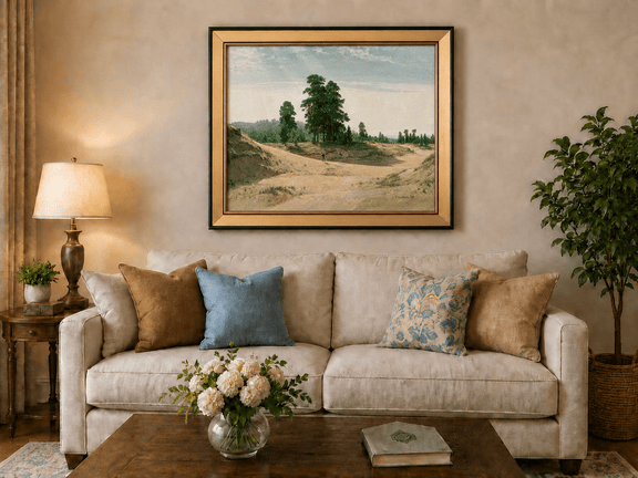 Framed hand-painted sandy forest clearing oil painting with a distant figure displayed above a neutral living room sofa.