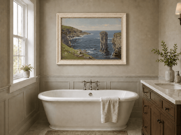 Framed hand-painted coastal oil painting with sea stacks, cliffs and churning ocean waves displayed above a freestanding bathtub.