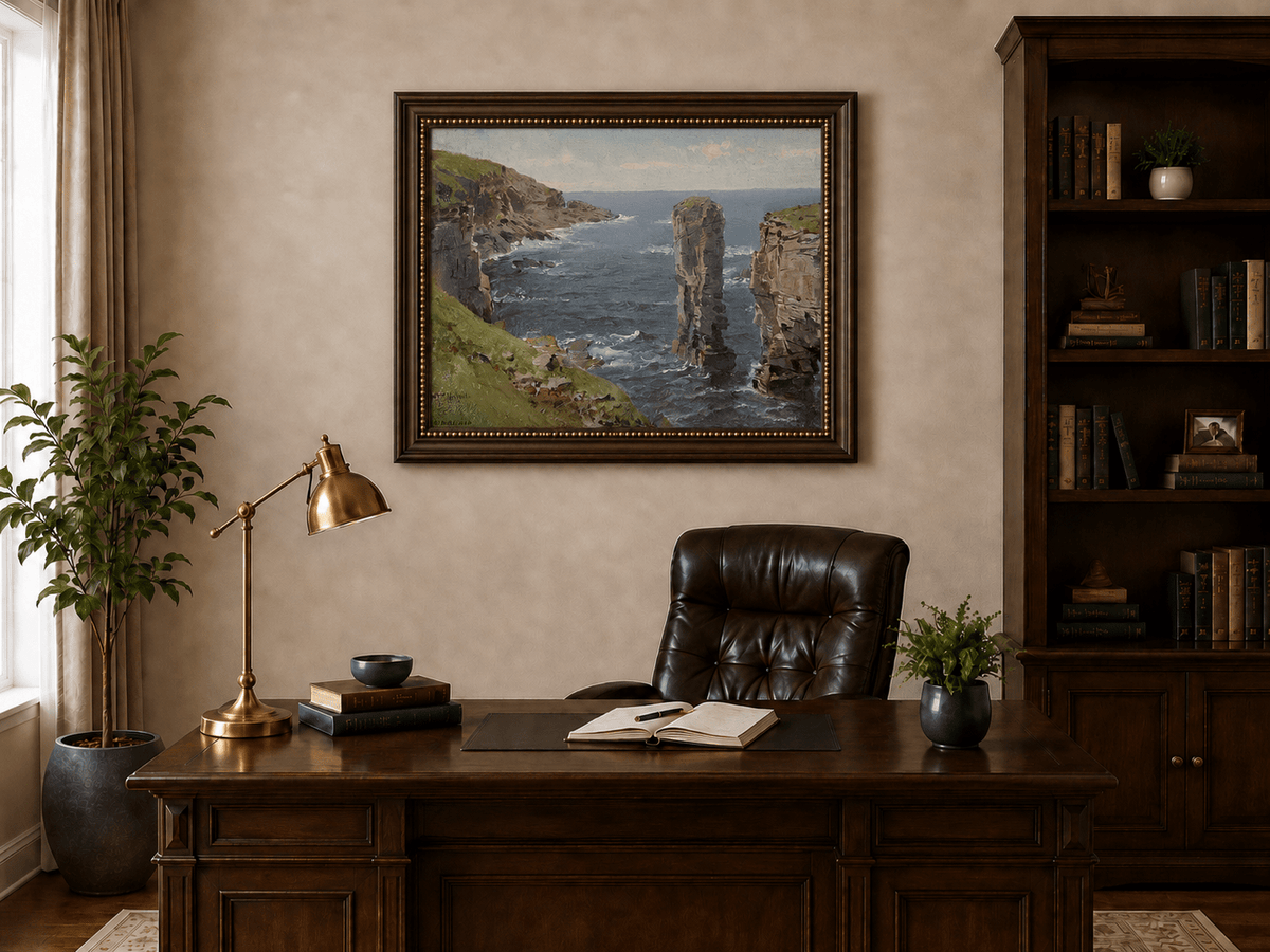 Framed hand-painted coastal oil painting with sea stacks, cliffs and churning ocean waves displayed above a traditional home office desk.
