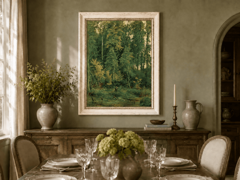 Framed hand-painted serene forest pond oil painting with leafy trees and still water displayed above a formal dining table.