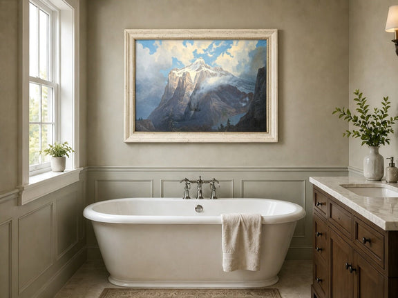 Framed hand-painted snow-capped mountain oil painting rising through luminous mist displayed above a freestanding bathtub.