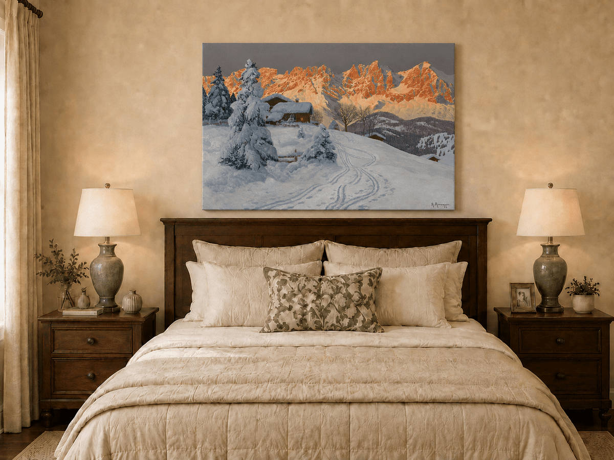 Unframed hand-painted winter alpine oil painting with a snowy cabin and mountains at sunset displayed above a wooden bed in a neutral bedroom.