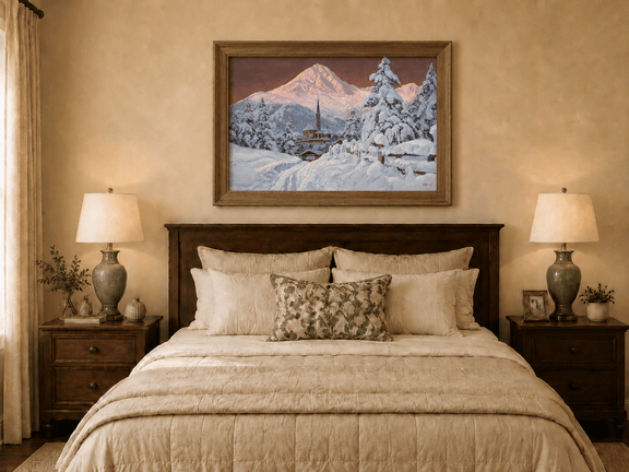 Framed hand-painted snowy alpine village oil painting with a church and pink mountain peaks displayed above a wooden bed in a neutral bedroom.