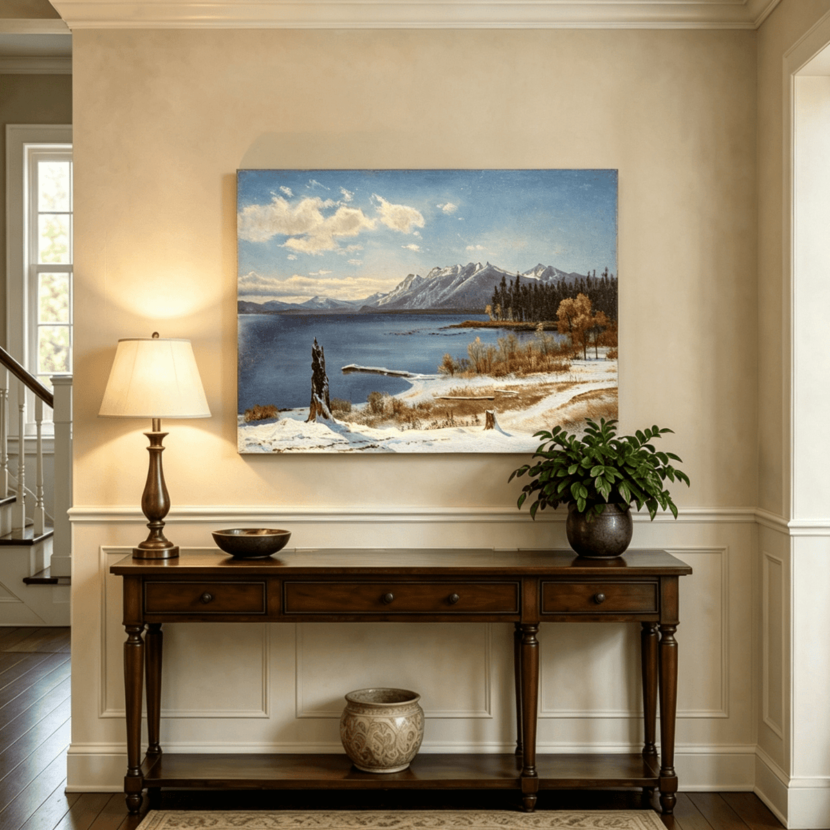Unframed hand-painted snowy lake oil painting with a winter path and distant mountain view displayed above an entryway console table.