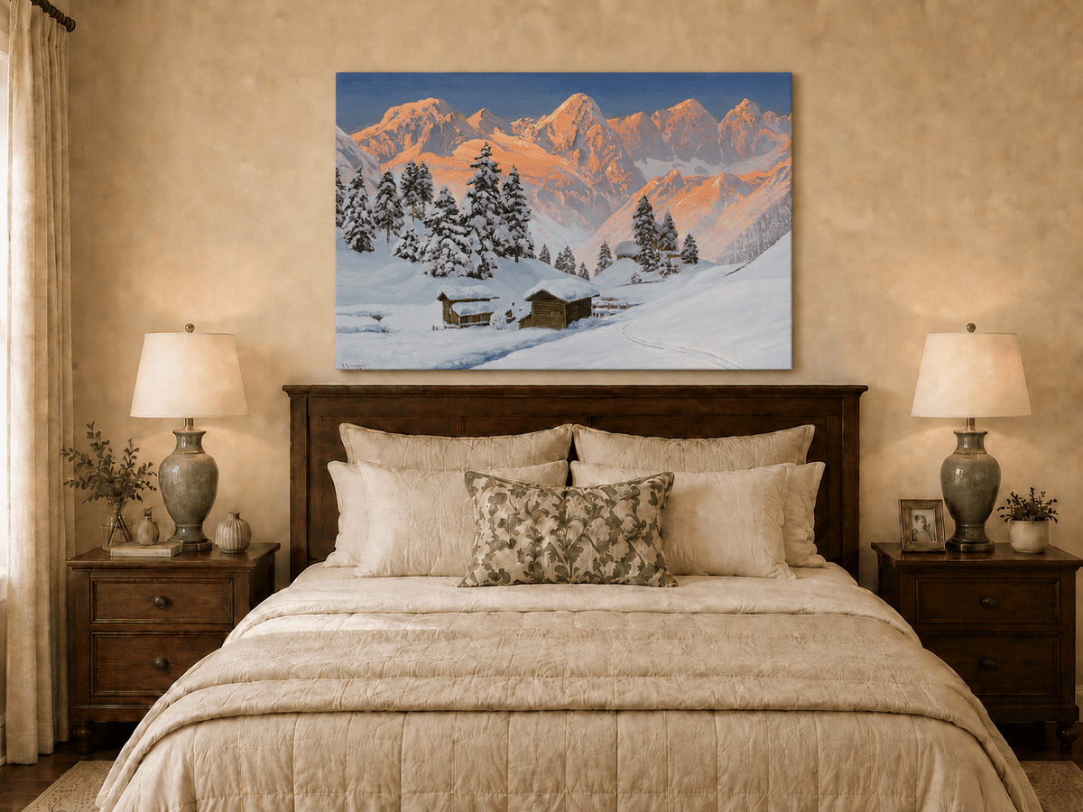 Unframed hand-painted snowy mountain oil painting with alpine huts glowing at sunset displayed above a wooden bed in a neutral bedroom.