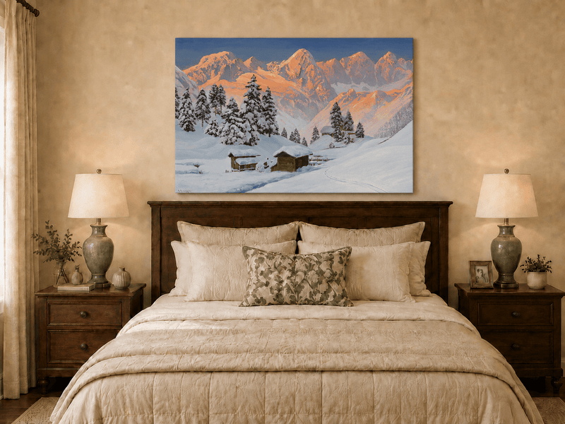 Unframed hand-painted snowy mountain oil painting with alpine huts glowing at sunset displayed above a wooden bed in a neutral bedroom.