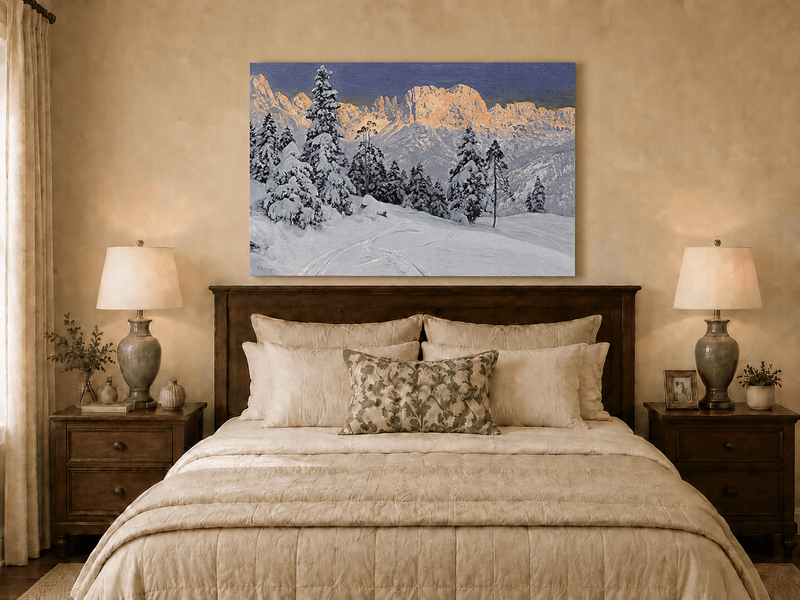 Unframed hand-painted winter mountain oil painting with snow-covered pine trees and footprints displayed above a wooden bed in a neutral bedroom.