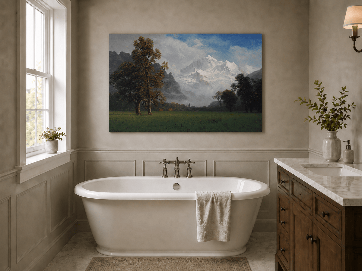 Unframed hand-painted snowy mountain valley oil painting with a meadow and tall trees displayed above a freestanding bathtub.