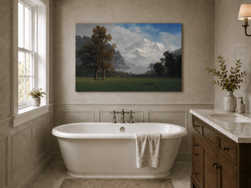 Unframed hand-painted snowy mountain valley oil painting with a meadow and tall trees displayed above a freestanding bathtub.
