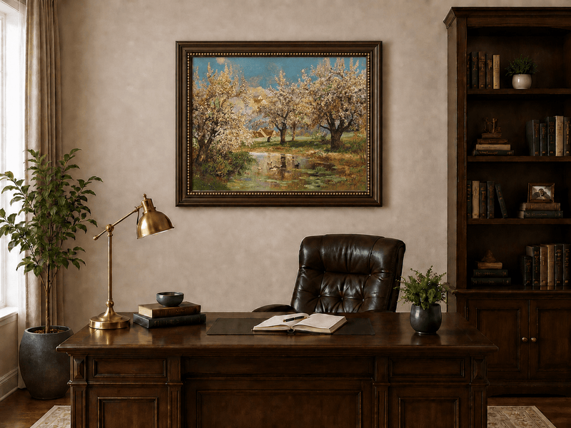 Framed hand-painted spring orchard oil painting with blossoming trees around a quiet pond displayed above a traditional home office desk.