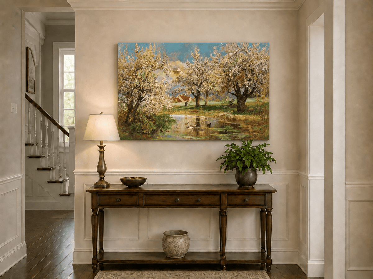 Unframed hand-painted spring orchard oil painting with blossoming trees around a quiet pond displayed above an entryway console table.