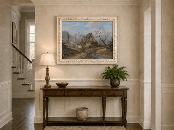 Framed hand-painted spring cottage oil painting beside a stream and blossoming trees displayed above an entryway console table.