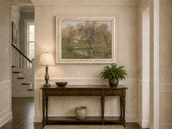 Framed hand-painted spring orchard oil painting with blossoming trees, a farmhouse and pond displayed above an entryway console table.