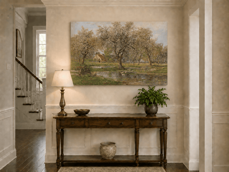 Unframed hand-painted spring orchard oil painting with blossoming trees, a farmhouse and pond displayed above an entryway console table.
