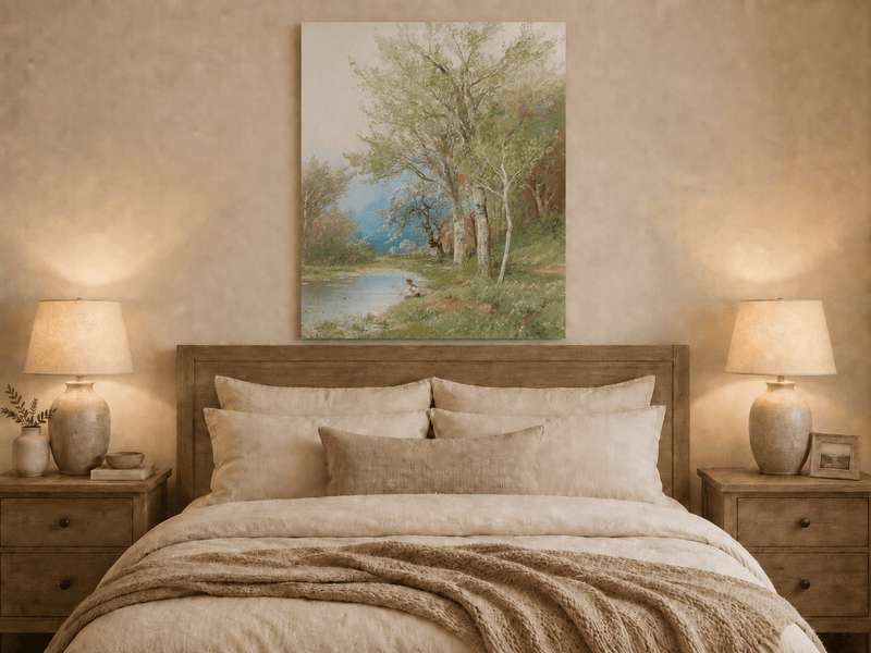 Unframed hand-painted spring river oil painting with a fisherman beneath leafy trees displayed above a wooden bed in a neutral bedroom.