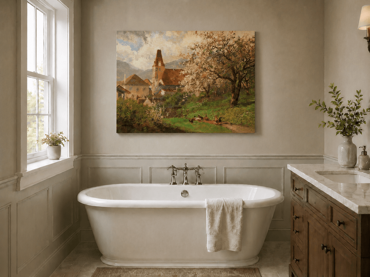 Unframed hand-painted spring village oil painting with a church and flowering tree displayed above a freestanding bathtub.