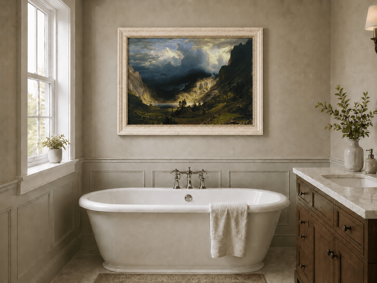 Framed hand-painted Rocky Mountains oil painting with a dramatic storm over Mount Rosalie displayed above a freestanding bathtub.