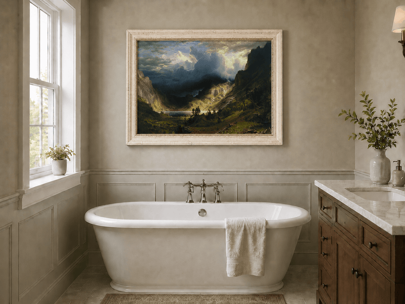 Framed hand-painted Rocky Mountains oil painting with a dramatic storm over Mount Rosalie displayed above a freestanding bathtub.