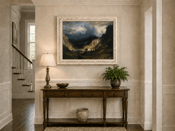 Framed hand-painted Rocky Mountains oil painting with a dramatic storm over Mount Rosalie displayed above an entryway console table.