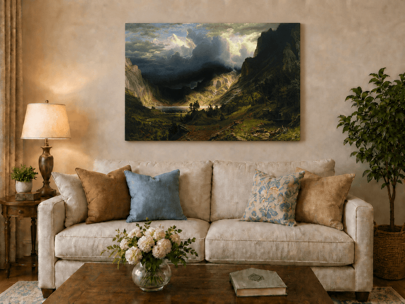 Unframed hand-painted Rocky Mountains oil painting with a dramatic storm over Mount Rosalie displayed above a neutral living room sofa.