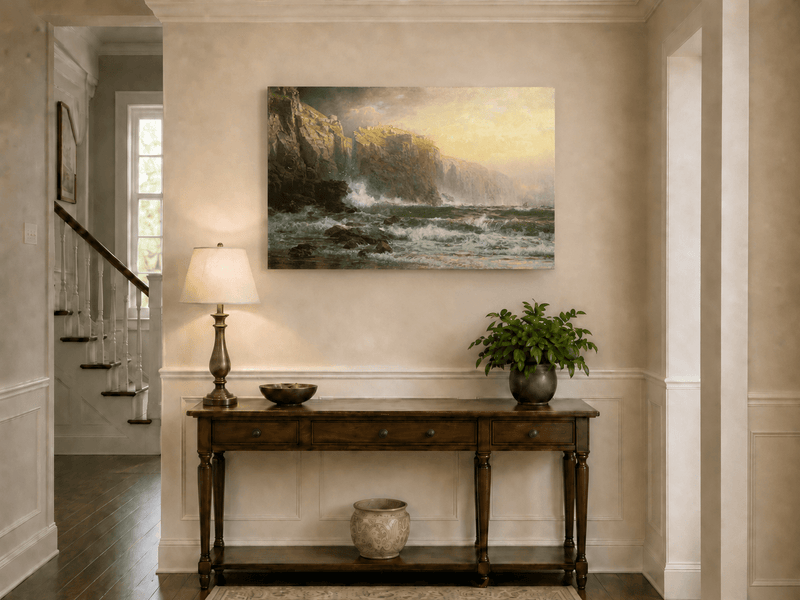 Unframed hand-painted stormy seascape oil painting with a reef, surf and golden coastal cliffs displayed above an entryway console table.