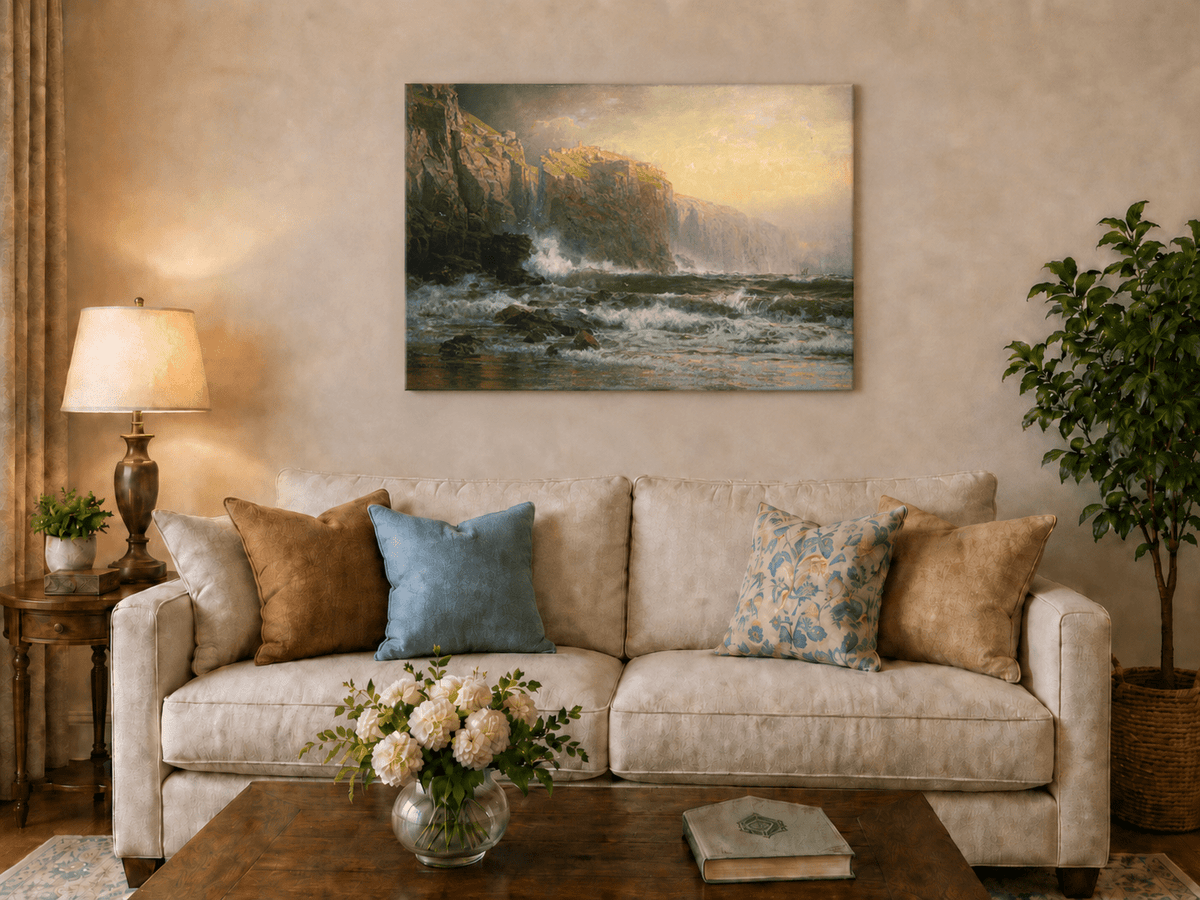 Unframed hand-painted stormy seascape oil painting with a reef, surf and golden coastal cliffs displayed above a neutral living room sofa.