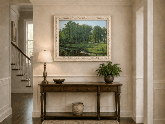 Framed hand-painted summer forest oil painting with a river, path and lush green trees displayed above an entryway console table.