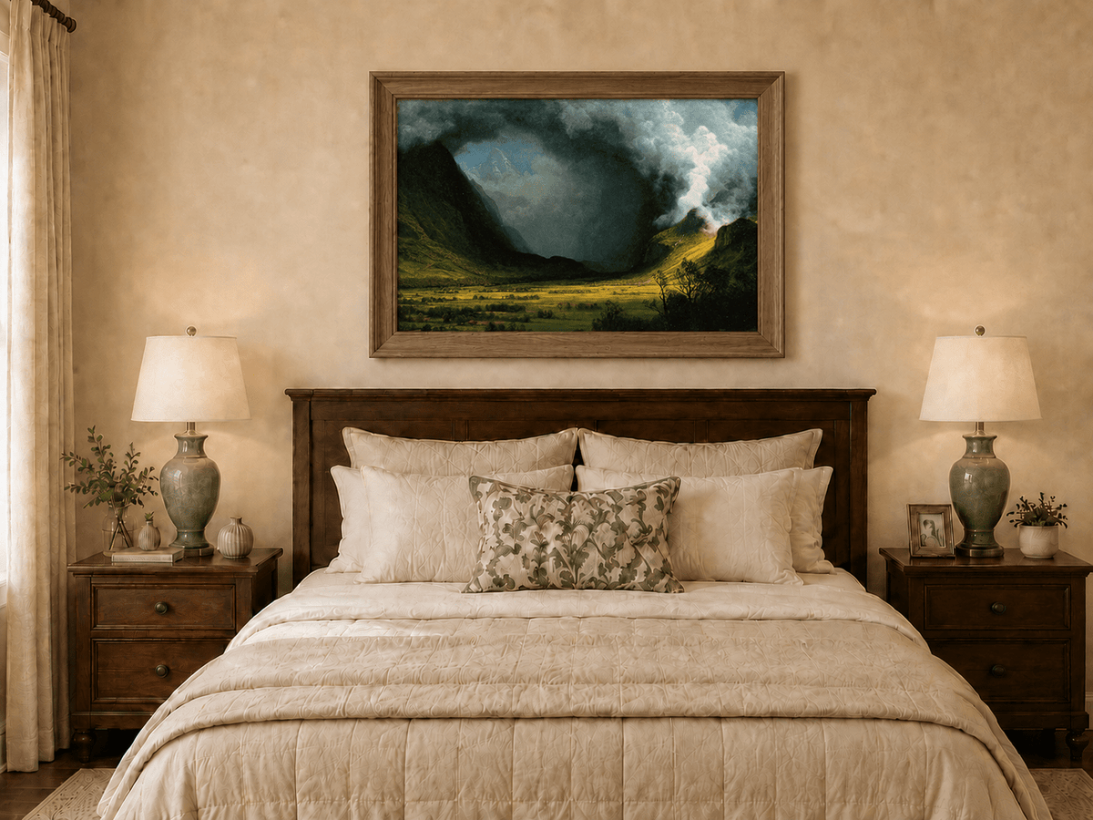 Framed hand-painted landscape oil painting with sunlight beneath dramatic storm clouds displayed above a wooden bed in a neutral bedroom.