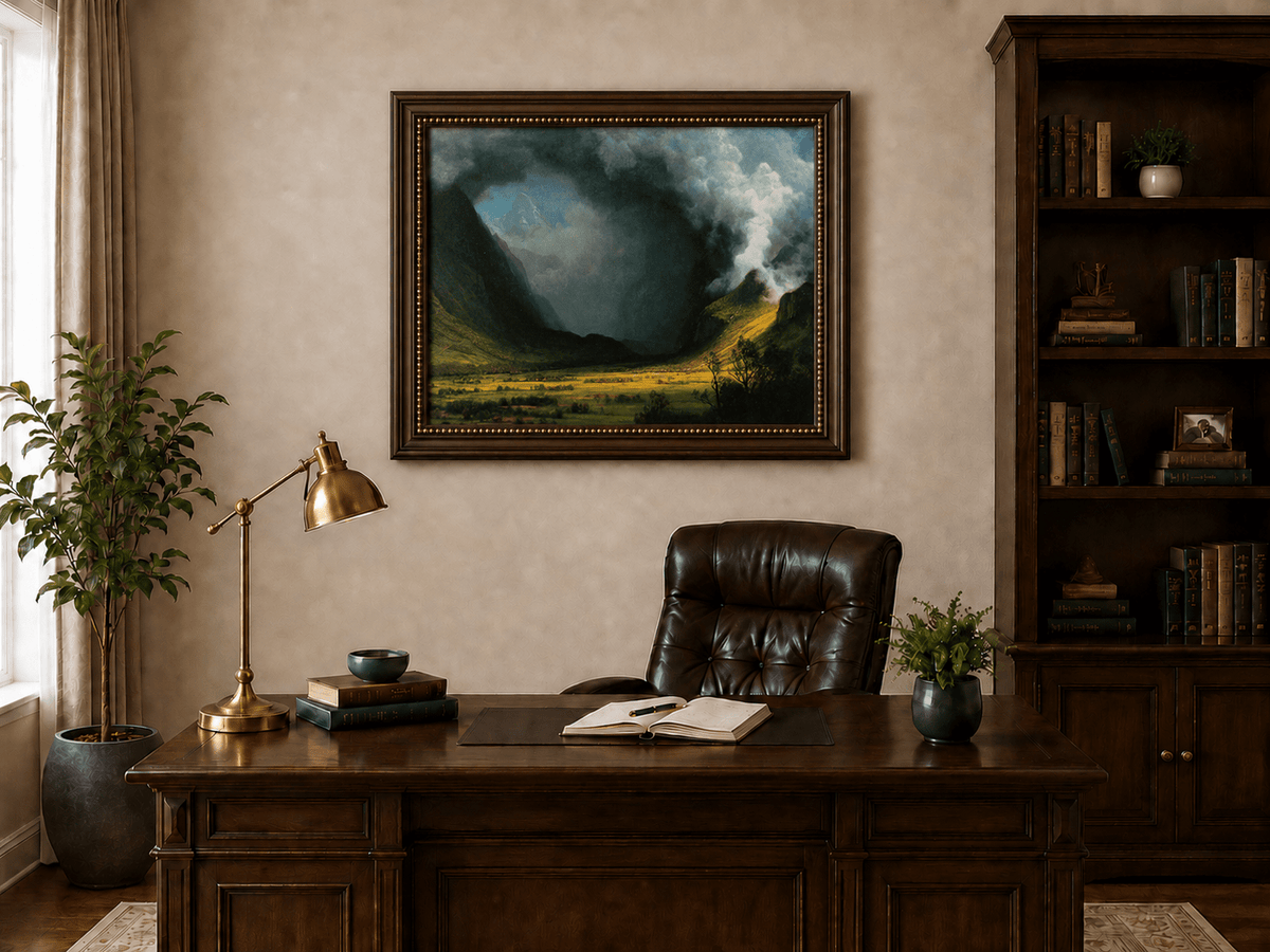 Framed hand-painted landscape oil painting with sunlight beneath dramatic storm clouds displayed above a traditional home office desk.
