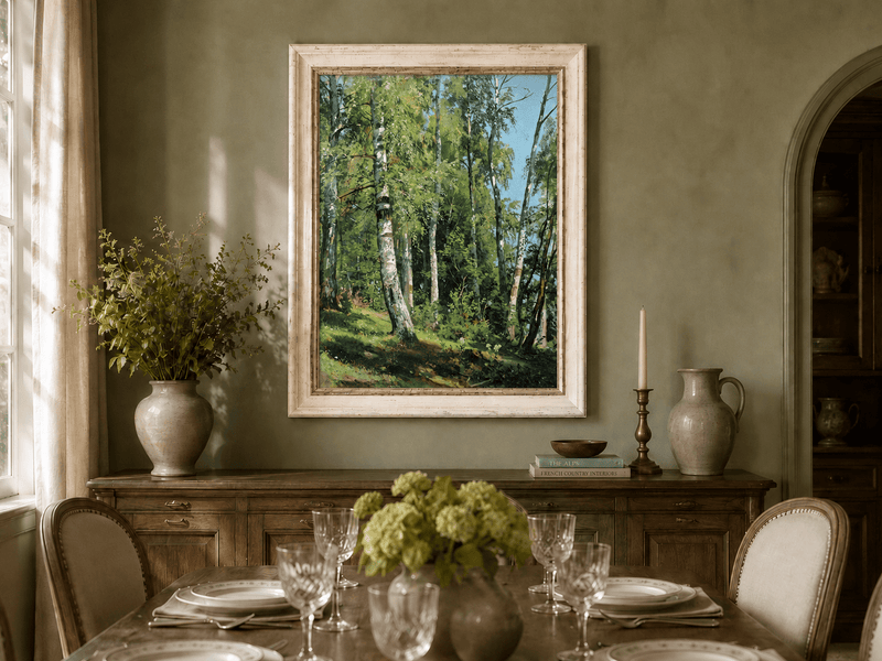 Framed hand-painted sunlit birch forest oil painting with a bright woodland clearing displayed above a formal dining table.