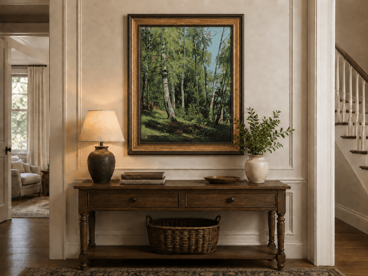 Framed hand-painted sunlit birch forest oil painting with a bright woodland clearing displayed above an entryway console table.