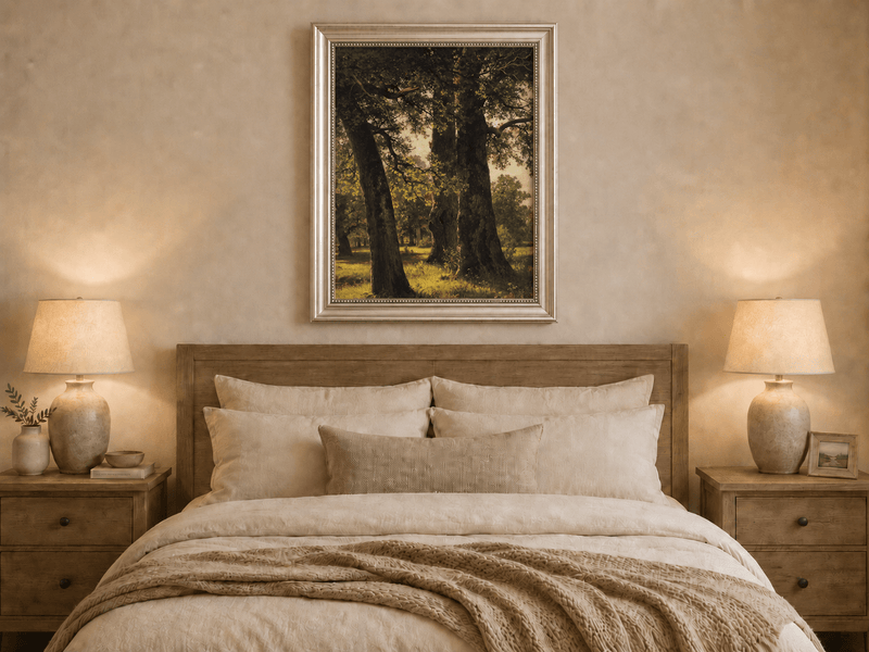 Framed hand-painted sunlit forest oil painting with massive ancient trees and golden ground displayed above a wooden bed in a neutral bedroom.