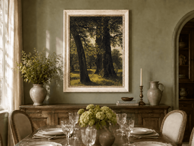 Framed hand-painted sunlit forest oil painting with massive ancient trees and golden ground displayed above a formal dining table.